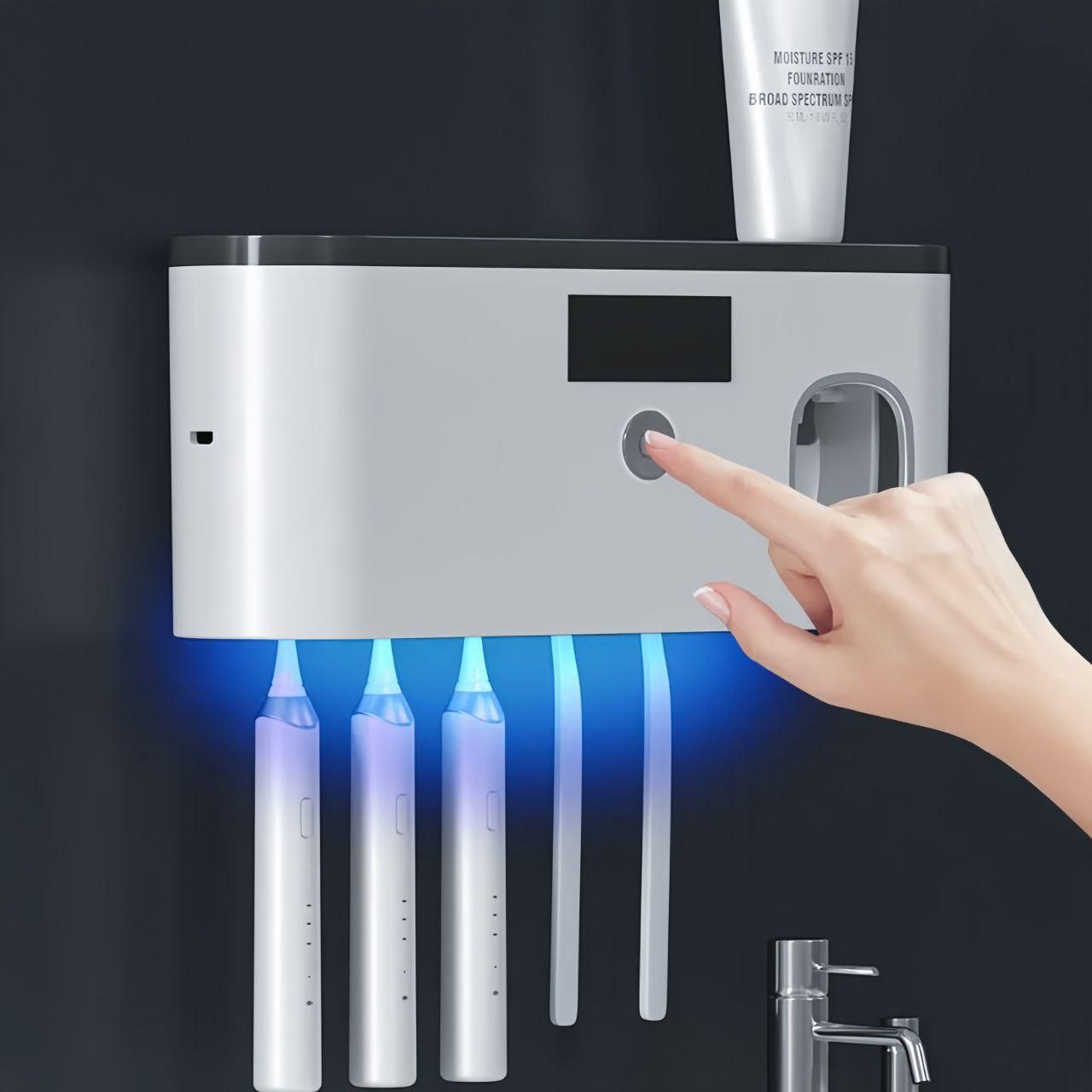Hand holding the Smart UV toothbrush storage unit with glowing light at the bottom.