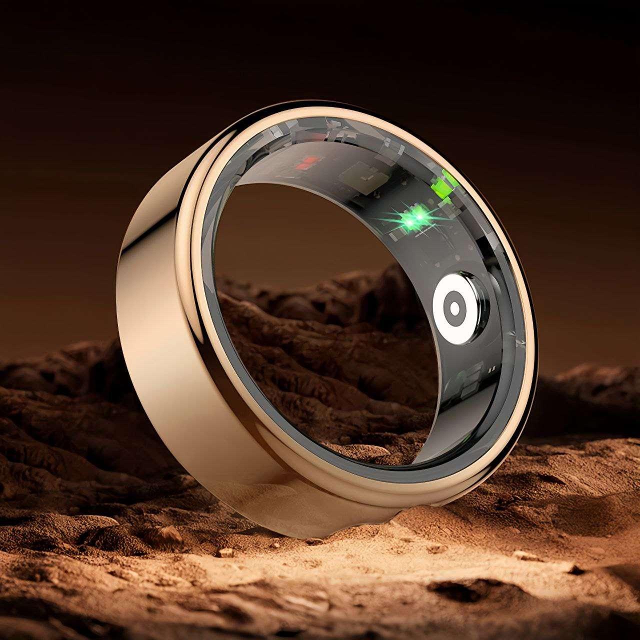 Gold smart ring placed on a desert surface, showcasing its transparent inner sensors and premium metallic finish for a high tech luxury appeal.